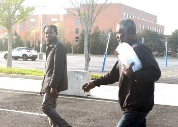 Rwandan genocide suspect Faustin Nsabumukunzi (right) and his son Thierry Balihuta outside federal court on Thursday